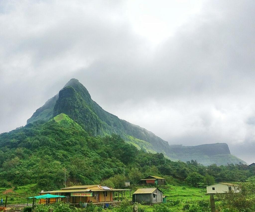 Beautiful monsoon trek in Maharashtra with hikers pausing to admire the panoramic valley views.