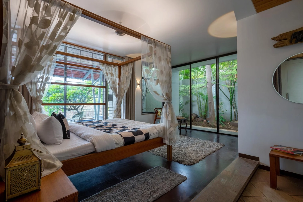 Cozy bedroom with a king-sized bed, soft linens, and warm ambient lighting
