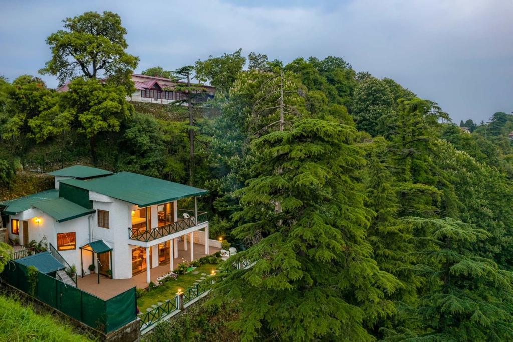 Villa surrounded by monsoon clouds and winding paths for monsoon treks for kids
