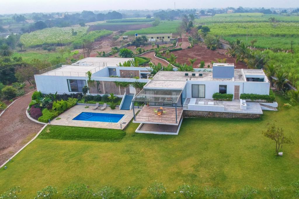 Cosy villa with a balcony overlooking rain-drenched hills, ideal for a relaxing break after a monsoon trek in Maharashtra