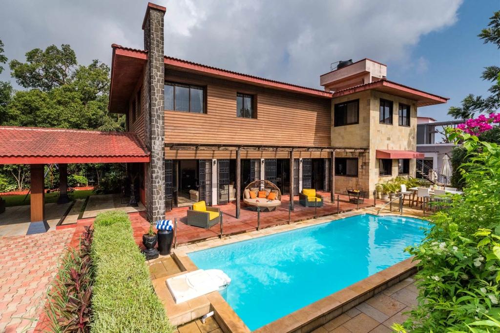 Modern villa with panoramic mountain views and an inviting terrace overlooking nature.