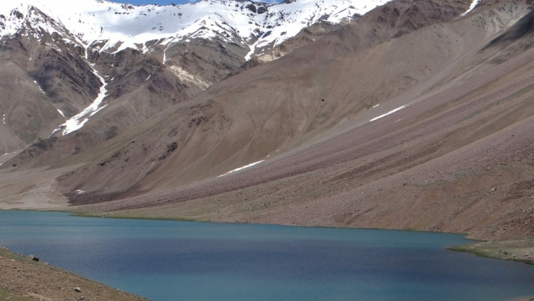 Chandratal Lake (Moon Lake) shimmering in blue at 4,300m altitude in Spiti Valley