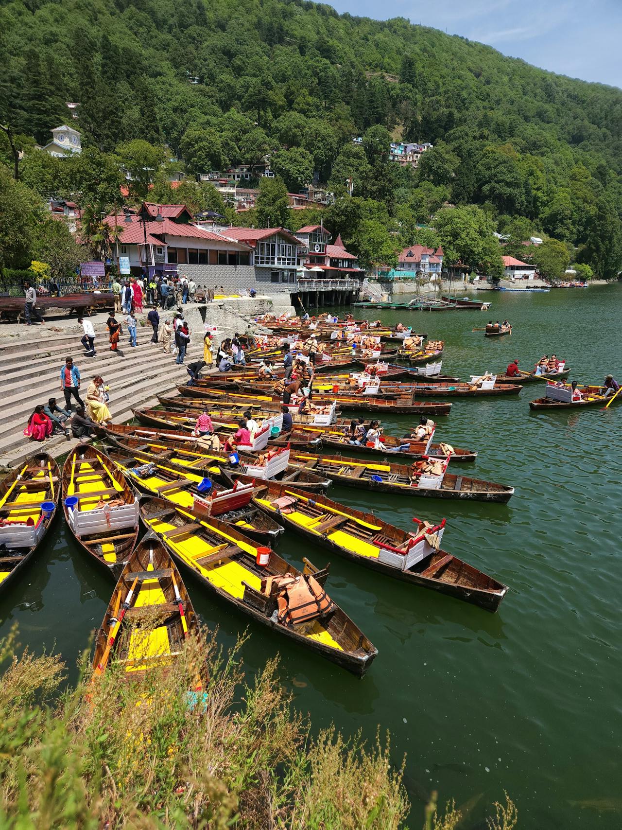 Boats on Naini Lake in Nainital surrounded by green hills